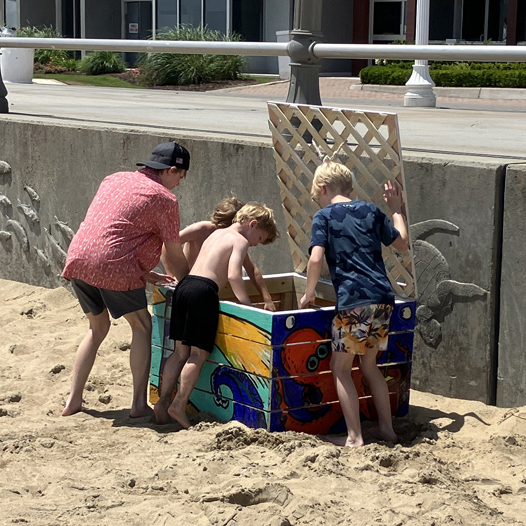 Kids enjoying the beach toy recycling toy box at virginia beach oceanfront
